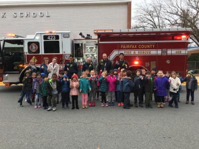 Photo of kindergarten students with firefighters