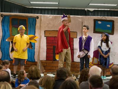 photos of students acting in the Play, "Tales from around the word"